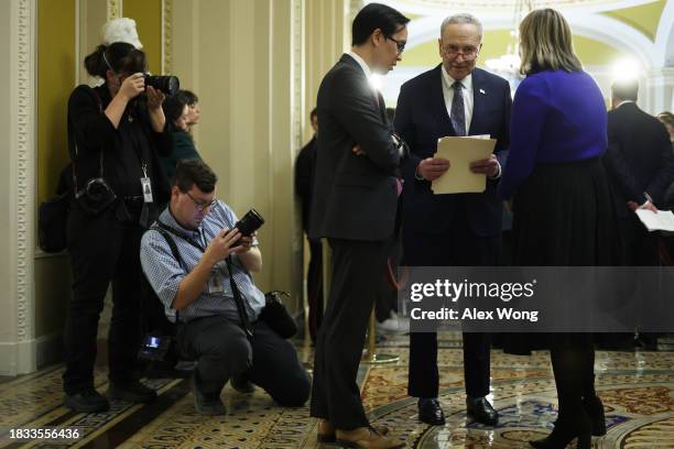 Senate Majority Leader Sen. Chuck Schumer talks to Communications Director Alex Nguyen and National Press Secretary Allison Biasotti during a news...