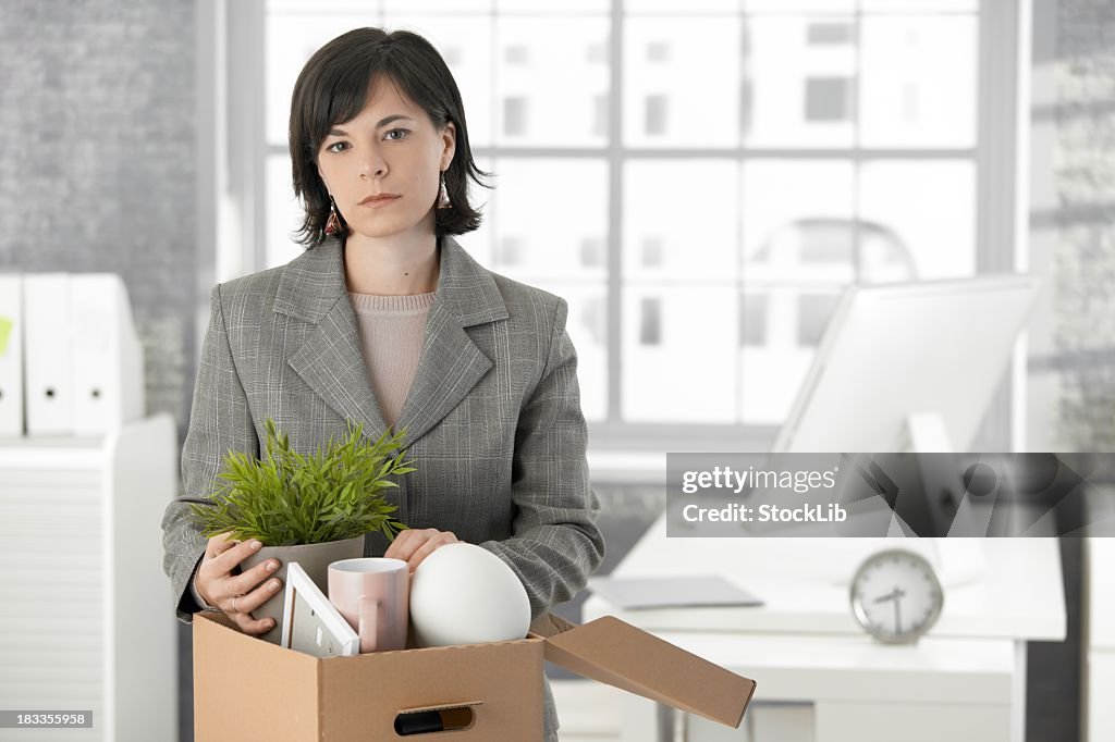 Woman in business suit with distressed expression is fired