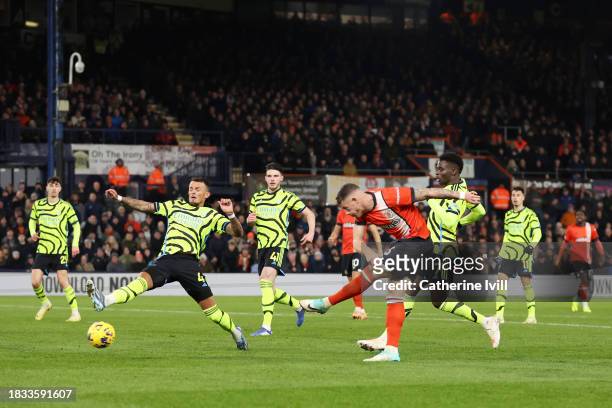 Ross Barkley of Luton Town scores the team's third goal whilst under pressure from Ben White of Arsenal during the Premier League match between Luton...