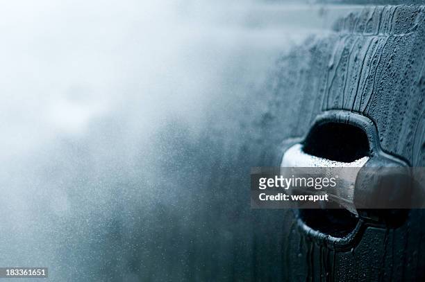 close up of a car door handle going through a car wash - auto druppel stockfoto's en -beelden
