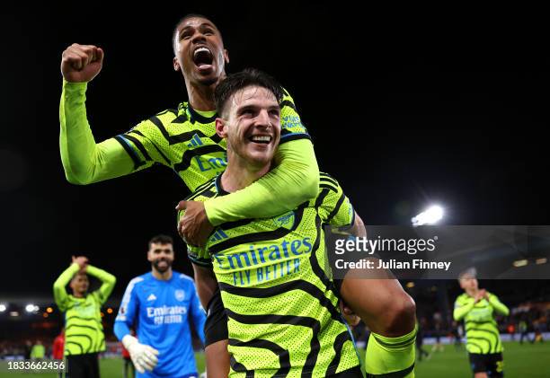 Declan Rice of Arsenal celebrates with teammate Gabriel after defeating Luton Town during the Premier League match between Luton Town and Arsenal FC...
