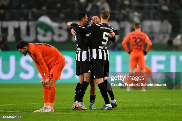 Fabio Chiarodia, Nathan Ngoumou and Marvin Friedrich of Borussia Moenchengladbach celebrate following the team's victory during the DFB cup round of...