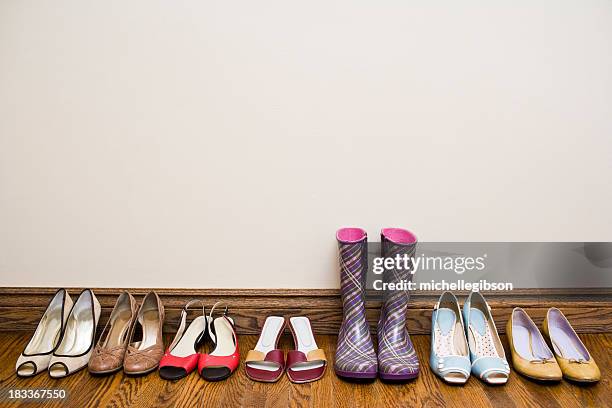 a row of shoes from heels to rain boots - shoe collection stockfoto's en -beelden