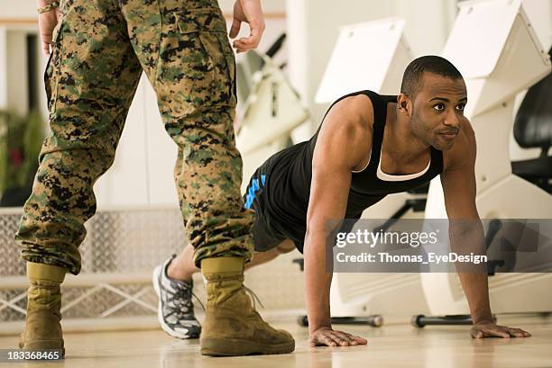 trainee doing burpees at a fitness bootcamp - military camp stock pictures, royalty-free photos & images