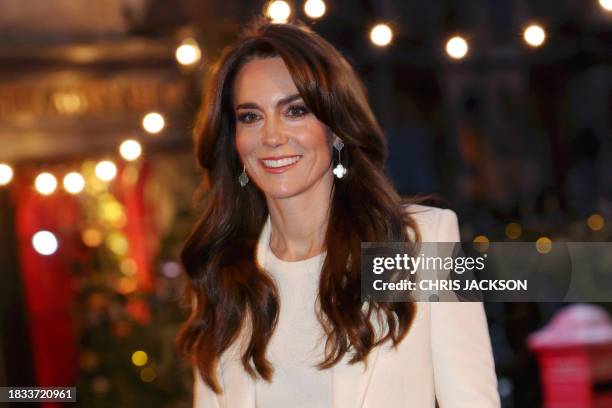 Britain's Catherine, Princess of Wales smiles as she arrives to attend the "Together At Christmas" Carol Service" at Westminster Abbey in London on...