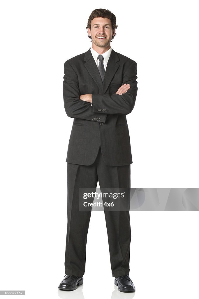 Confident businessman standing with arms crossed