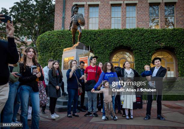 Los Angeles, CA People gather as the Chabad Jewish Student Center at USC celebrates the first day of Hanukkah by lighting the first candle on a...