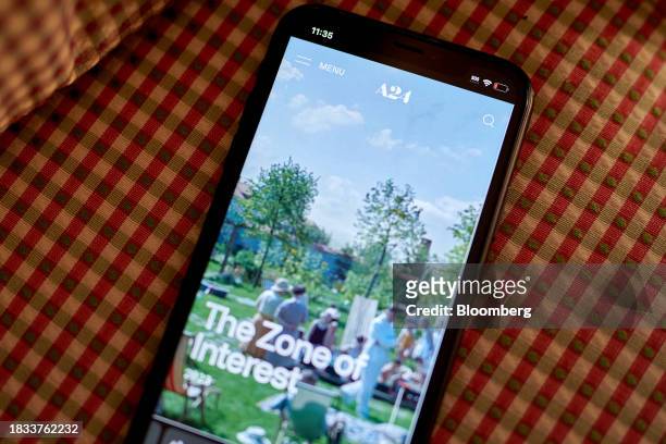 The A24 website on a smartphone arranged in New York, US, on Friday, Dec. 8, 2023. Independent film company A24 will run its new movies exclusively...