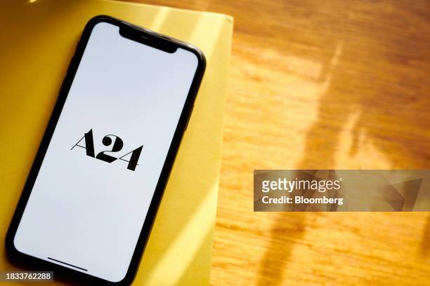 The A24 logo on a smartphone arranged in New York, US, on Friday, Dec. 8, 2023. Independent film company A24 will run its new movies exclusively on...