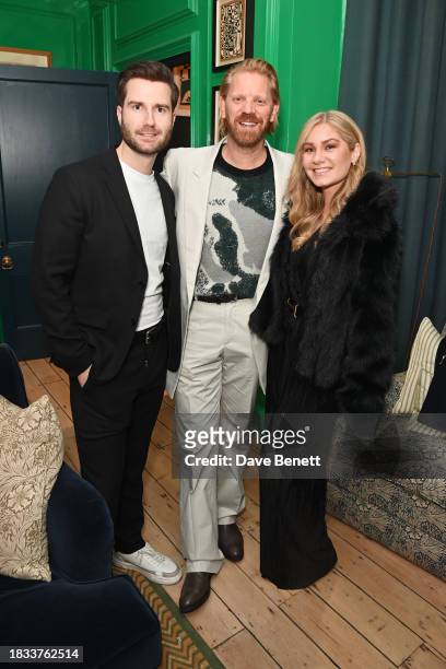 Michael Hillberg, Alistair Guy and Helena Hillberg attend Alistair Guy's birthday cocktail party at Hackett London, Savile Row, on December 8, 2023...