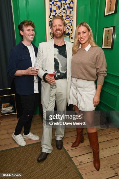 Caolan Robertson, Alistair Guy and Hannah Park attend Alistair Guy's birthday cocktail party at Hackett London, Savile Row, on December 8, 2023 in...