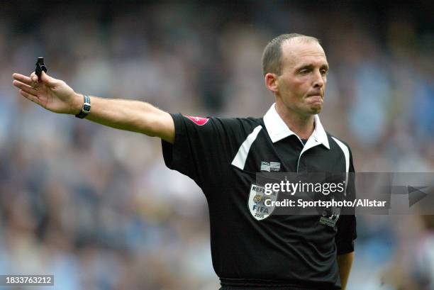 September 18: Referee Mike Dean pointing during the Premier League match between Manchester City and Bolton Wanderers at City Of Manchester Stadium...