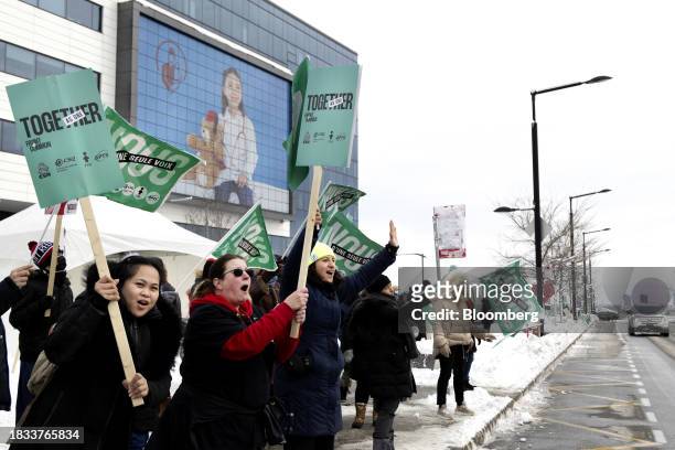 Public sector workers and supporters encourage motorists to honk during a strike outside McGill University Health Centre in Montreal, Quebec, Canada,...