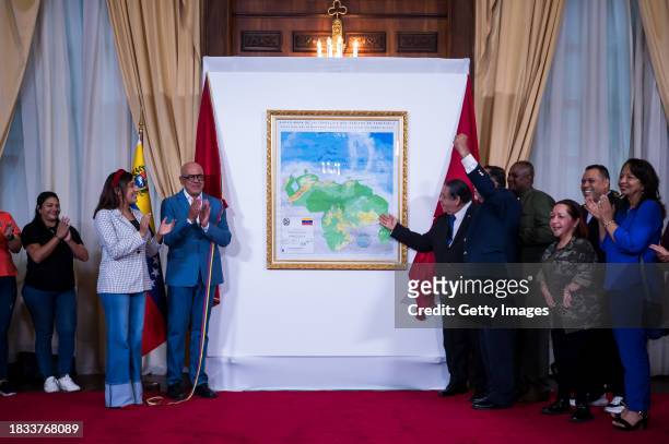President of the National Assembly Jorge Rodriguez , deputy Hermann Escarra and deputies celebrate during an act to unveil the updated map annexing...
