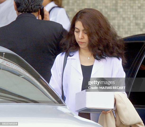 An unidentified woman, a member of the group of six experts of Chilean Legal Medical Institute, leaves the Military Hospital in Santiago, Chile,...
