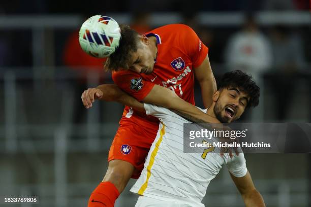 Gael Gibert of the Clemson Tigers and Marcus Caldeira of the West Virginia Mountaineers jump for a header during the Division I Men's Soccer...