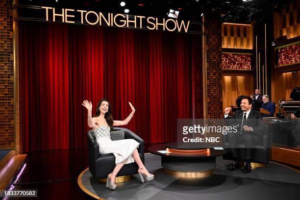Episode 1887 -- Pictured: Actress Anne Hathaway and host Jimmy Fallon during "What's Behind Me" on Friday, December 8, 2023 --