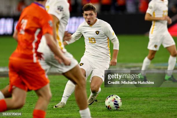 Ryan Crooks of the West Virginia dribbles against the Clemson Tigers during the Division I Men's Soccer Semifinals held at the Lynn Family Stadium on...