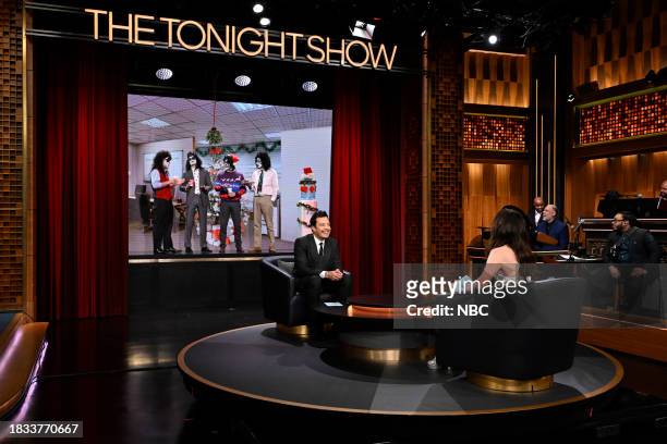 Episode 1887 -- Pictured: Host Jimmy Fallon and actress Anne Hathaway during "What's Behind Me" on Friday, December 8, 2023 --