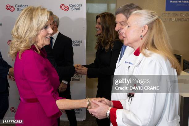 Doctor Noel C Bairey-Merz greets US First Lady Jill Biden during a tour of the Van Eyk lab at Cedars-Sinai Medical Center in Los Angeles on December...