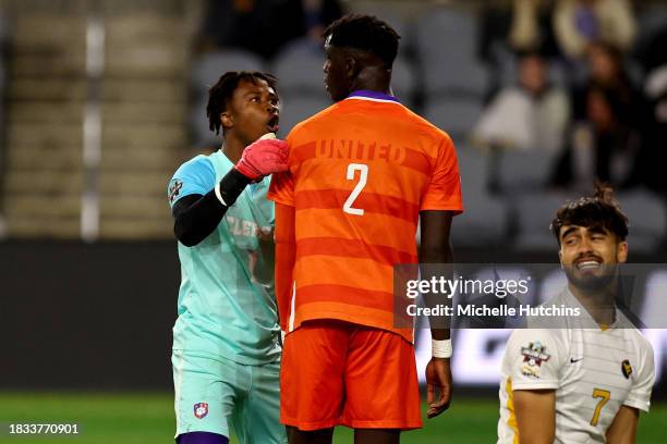 Joseph Andema speaks with Pape Mar Boye of the Clemson Tigers against the West Virginia Mountaineers during the Division I Men's Soccer Semifinals...