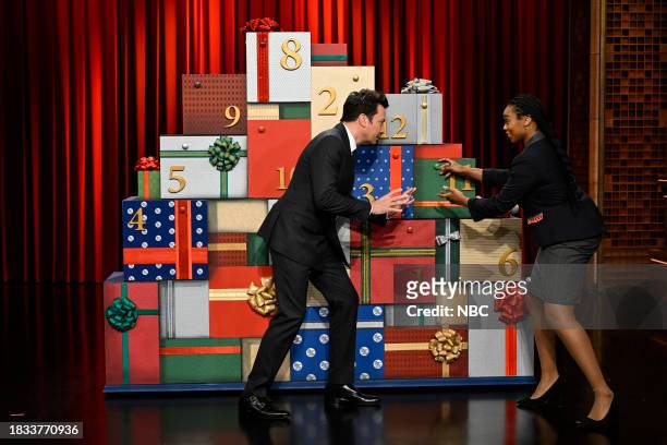 Episode 1887 -- Pictured: Host Jimmy Fallon and an NBC Page during "12 Days of Xmas Sweaters - Door 11" on Friday, December 8, 2023 --