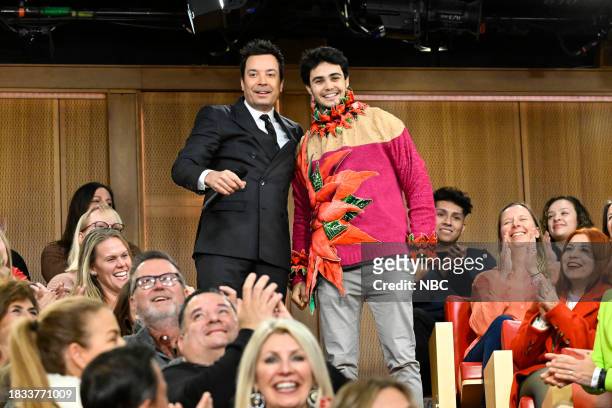 Episode 1887 -- Pictured: Host Jimmy Fallon with the winning audience member during "12 Days of Xmas Sweaters - Door 11" on Friday, December 8, 2023...