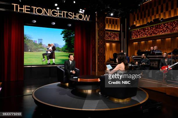 Episode 1887 -- Pictured: Host Jimmy Fallon and actress Anne Hathaway during "What's Behind Me" on Friday, December 8, 2023 --