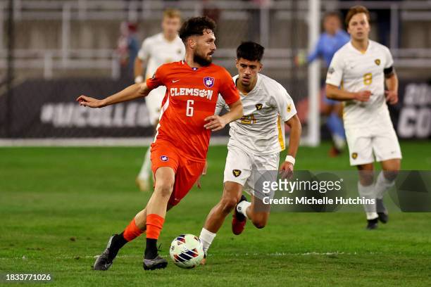 Joran Gerbet of the Clemson Tigers dribbles against the West Virginia Mountaineers during the Division I Men's Soccer Semifinals held at the Lynn...