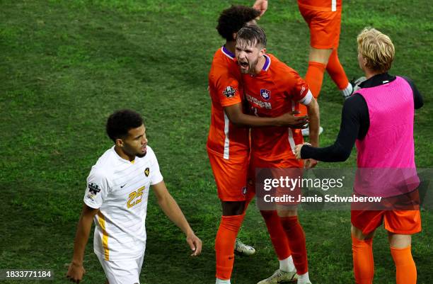 The Clemson Tigers celebrate their victory over the West Virginia Mountaineers during the Division I Men's Soccer Semifinals held at the Lynn Family...