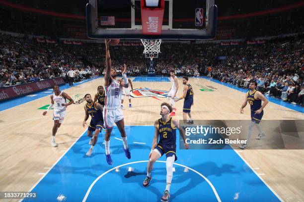 Aaron Wiggins of the Oklahoma City Thunder drives to the basket during the game against the Golden State Warriors on December 8, 2023 at Paycom Arena...