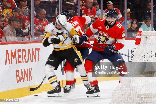 Vinnie Hinostroza of the Pittsburgh Penguins and Oliver Ekman-Larsson of the Florida Panthers battle for control of the puck during second period...