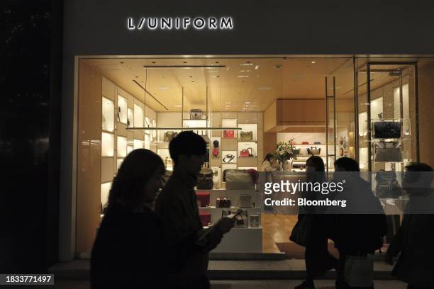 Pedestrians walk past a store in the Marunouchi area of Tokyo, Japan, on Friday, Japan, on Dec. 8, 2023. Inflation data are well above the Bank of...