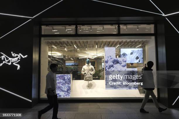 Pedestrians walk past an Arc'teryx store in the Marunouchi area of Tokyo, Japan, on Friday, Japan, on Dec. 8, 2023. Inflation data are well above the...