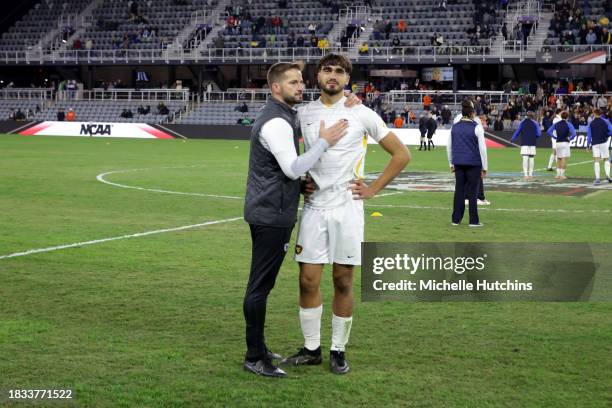 Head Coach Dan Stratford of the West Virginia Mountaineers consoles Marcus Caldeira after the loss to the Clemson Tigers during the Division I Men's...