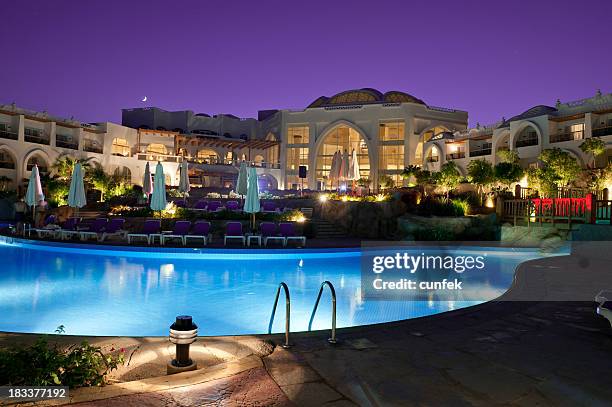 resort pool at night - aqua star pool stock pictures, royalty-free photos & images