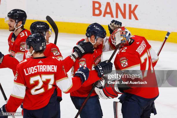 Teammates congratulate Goaltender Sergei Bobrovsky of the Florida Panthers after the 3-1 win against the Pittsburgh Penguins at the Amerant Bank...