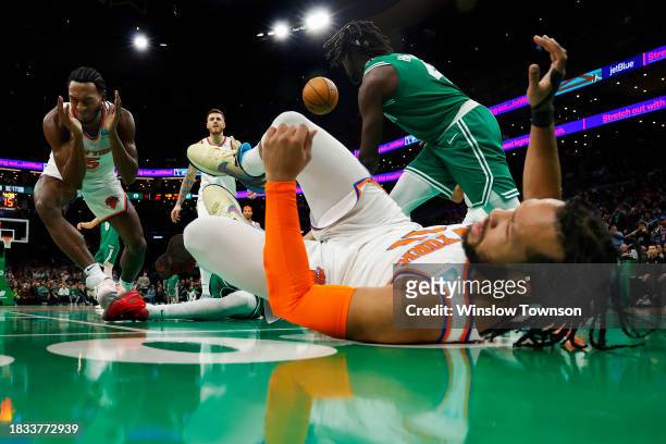Immanuel Quickley of the New York Knicks and Jalen Brunson hit the deck after a collision with Jrue Holiday of the Boston Celtics during the second...