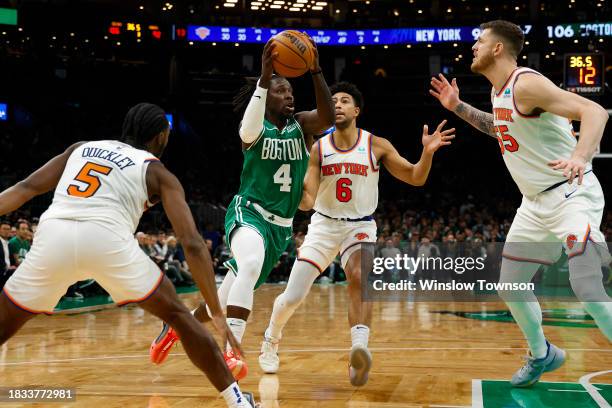 Jrue Holiday of the Boston Celtics goes past Quentin Grimes of the New York Knicks during the second half at TD Garden on December 8, 2023 in Boston,...