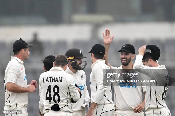 New Zealand's players celebrate after the dismissal of Bangladesh's Mominul Haque during the fourth day of the second Test cricket match between...