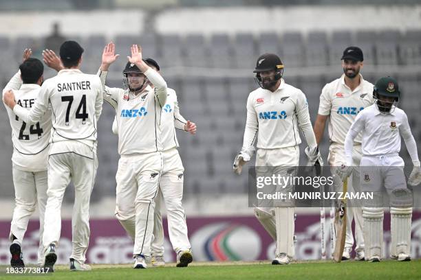 New Zealand's players celebrate after the dismissal of Bangladesh's Mominul Haque during the fourth day of the second Test cricket match between...