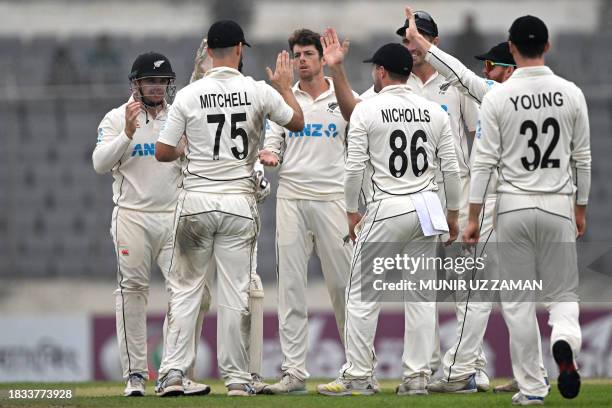 New Zealand's players celebrate after the dismissal of Bangladesh's Mushfiqur Rahim during the fourth day of the second Test cricket match between...
