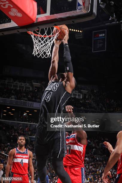 Harry Giles III of the Brooklyn Nets drives to the basket during the game against the Washington Wizards on December 8, 2023 at Barclays Center in...