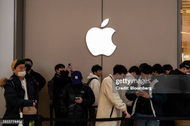 Customers wait in line to enter the new Apple Inc. Store inside the Starfield mall during its opening in Hanam, South Korea, on Saturday, Dec. 9,...