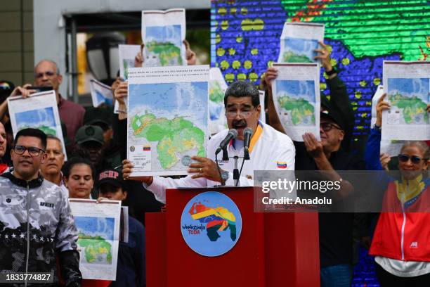 President of Venezuela Nicolas Maduro shows a national map during a march in favor of the Venezuelan position regarding the dispute over the...