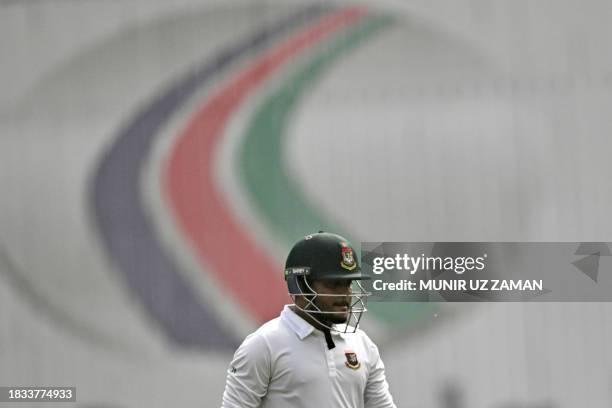 Bangladesh's Zakir Hasan walks back to the pavilion after his dismissal by New Zealand's Ajaz Patel during the fourth day of the second Test cricket...