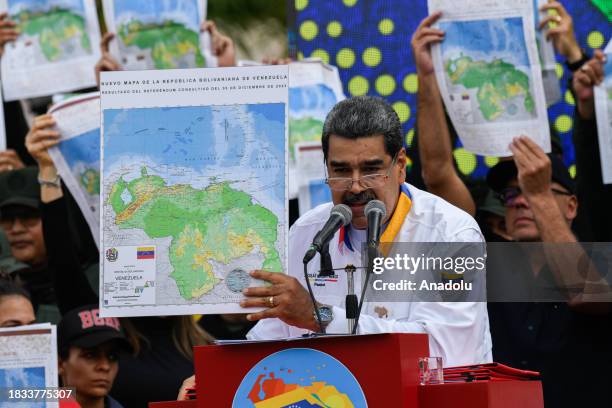 President of Venezuela Nicolas Maduro shows a national map during a march in favor of the Venezuelan position regarding the dispute over the...