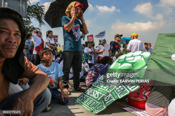 Protesters take part in the Global Day of Action for Climate Justice along Commonwealth Avenue in Quezon City on December 9 to demand urgent climate...