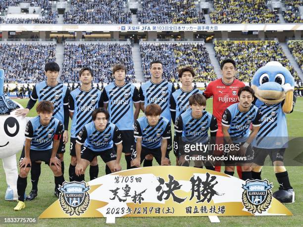 Kawasaki Frontale players pose for a team photo ahead of the Emperor's Cup football final against Kashiwa Reysol on Dec. 9 at Tokyo's National...