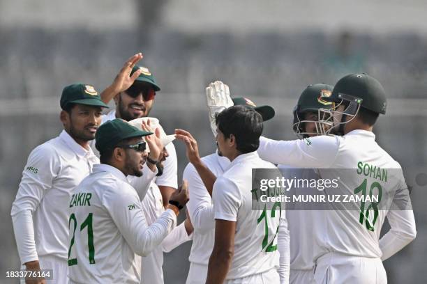 Bangladesh's players celebrate after the dismissal of New Zealand's Kane Williamson during the fourth day of the second Test cricket match between...